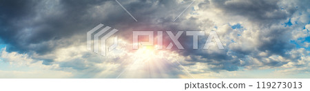 Dramatic cloudy sky at sunset. Cloudy sky background. Horizontal banner 119273013
