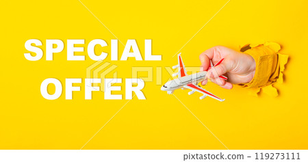 A hand holding a toy airplane with the words Special Offer written below it A hand holding a toy airplane with the words Special Offer written below it 119273111