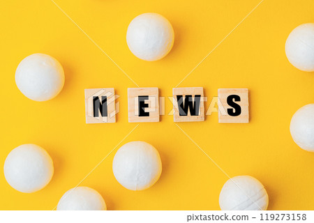 A yellow background with a large group of white balls scattered around it 119273158