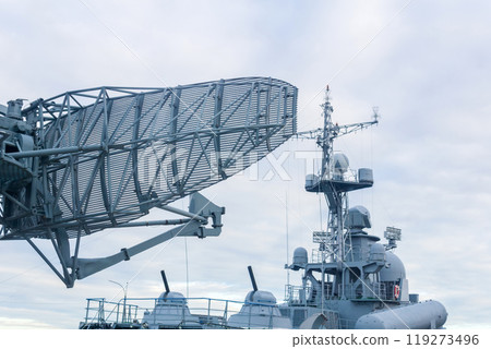 military background, naval radar antenna close up and warship in the background 119273496