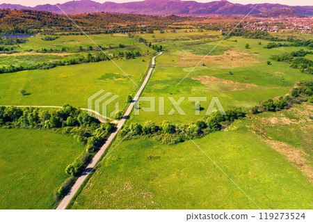 Drone view of the countryside. Road, meadows, and the village in the foothills of the Carpathians 119273524