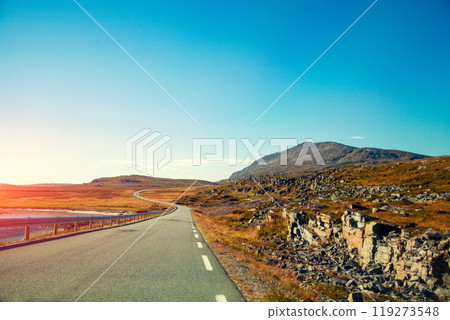 Driving a car on mountain road. Nature Norway. Polar circle. The way to Nordkapp Driving a car on mountain road. Nature Norway. Polar circle. The way to Nordkapp 119273548