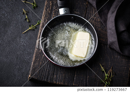 Melted butter on in iron pan 119273667
