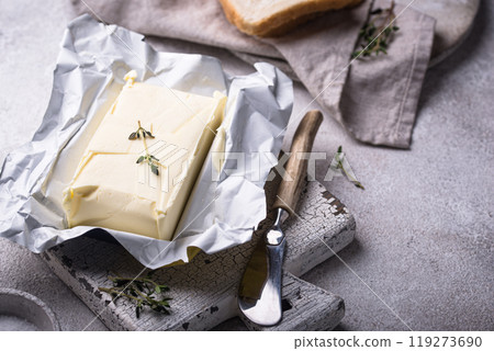 Fresh butter on grey backgrouns. 119273690