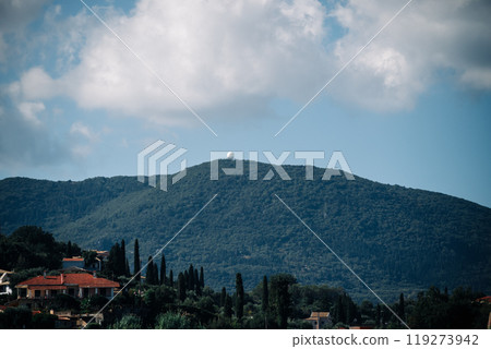A mountain with a telescope on top and houses in the distance A mountain with a telescope on top and houses in the distance 119273942