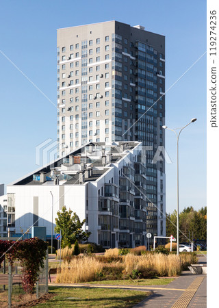 Modern high-rise apartment buildings in a residential area showcasing urban living and property 119274236