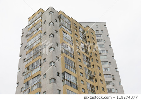 Modern high-rise apartment building in a residential area highlighting urban living and housing 119274377