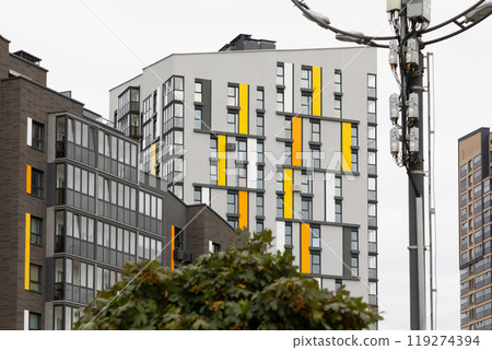 Modern high-rise apartment buildings in a residential area showcasing unique architectural designs Modern high-rise apartment buildings in a residential area showcasing unique architectural designs 119274394