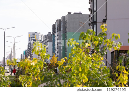 Modern residential area featuring high-rise apartment buildings under bright daylight with greenery Modern residential area featuring high-rise apartment buildings under bright daylight with greenery 119274395