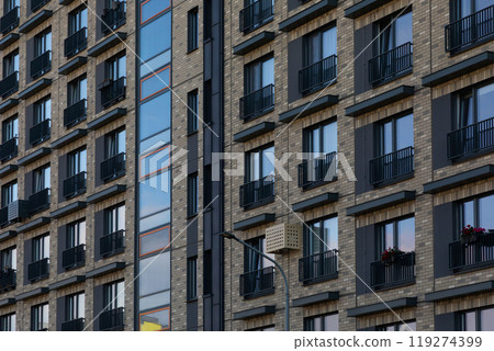 Modern high-rise apartment buildings in a residential area showcasing diverse window styles and 119274399