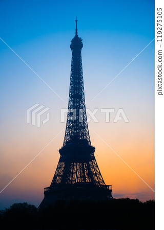 As dawn breaks, the Eiffel Tower silhouettes against a colorful sky, while the tranquil Seine River reflects the soft hues of morning in Paris, creating a stunning view. As dawn breaks, the Eiffel Tower silhouettes against a colorful sky, while the tranquil Seine River reflects the soft hues of morning in Paris, creating a stunning view. 119275105