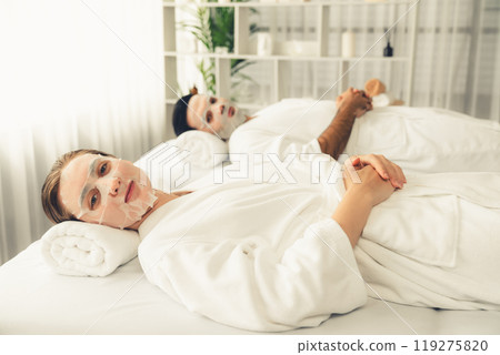 Woman customer indulges in rejuvenating with facial skincare mask. Quiescent 119275820