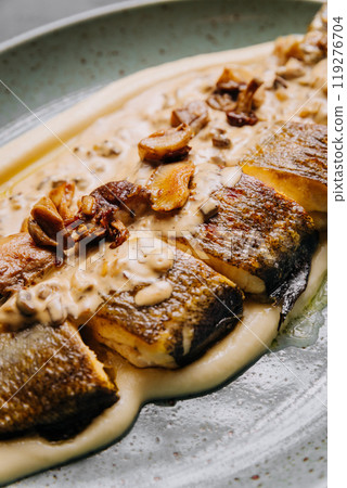 Close-up of roasted fish fillet with creamy mushroom sauce, culinary and food photography Close-up of roasted fish fillet with creamy mushroom sauce, culinary and food photography 119276704