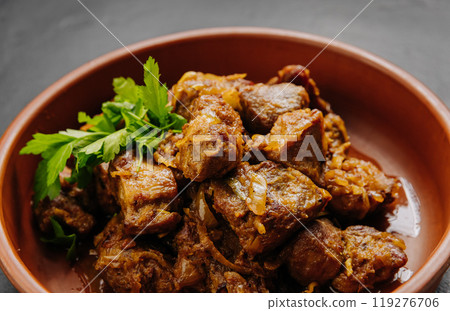 Close up of homemade roasted meat with onions, herbs. Perfect for food blogs, cookbooks, and menus Close up of homemade roasted meat with onions, herbs. Perfect for food blogs, cookbooks, and menus 119276706