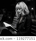 Beautiful American woman reading a book on a park bench (monochrome) 119277151