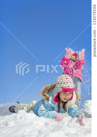 Sisters playing in the snow park 119278508