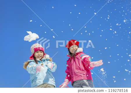 Sisters playing in the snow park 119278516