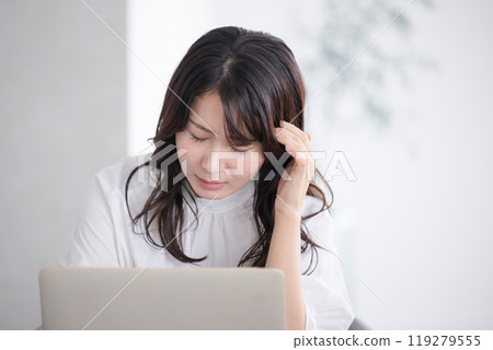 Woman suffering from eye strain and headaches thinking due to computer and overwork Woman suffering from eye strain and headaches thinking due to computer and overwork 119279555