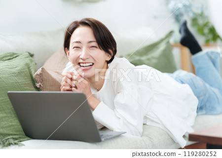 A woman relaxing on the sofa A woman relaxing on the sofa 119280252