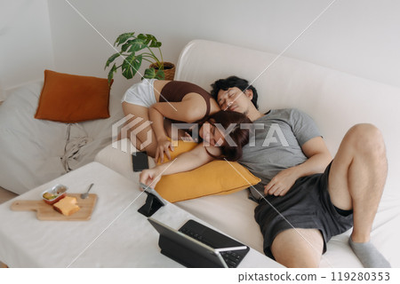 Couple lover relaxed and cuddling together in their apartment. 119280353