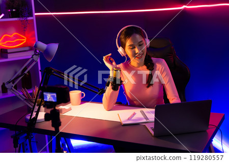 Smiling creative young beautiful Asian influencer talking in channel. Stratagem. Smiling creative young beautiful Asian influencer talking in channel. Stratagem. 119280557