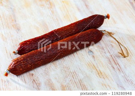 Smoked sausage on wooden surface Smoked sausage on wooden surface 119280948