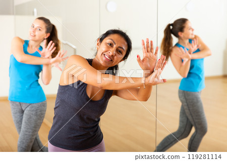 Group of smiling women training sport dance Group of smiling women training sport dance 119281114