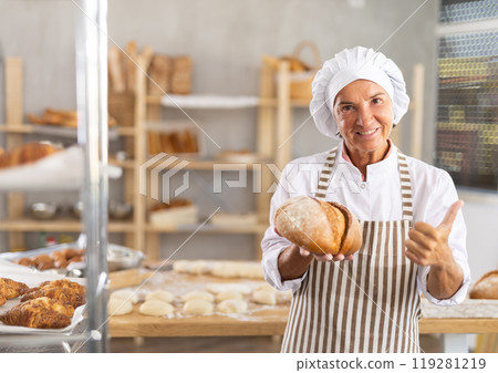 Elderly female baker with homemade bread Elderly female baker with homemade bread 119281219