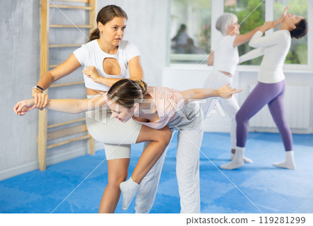 Two young women training self-defense techniques 119281299