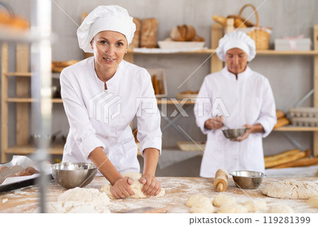 Two women bakers making dough in workshop Two women bakers making dough in workshop 119281399