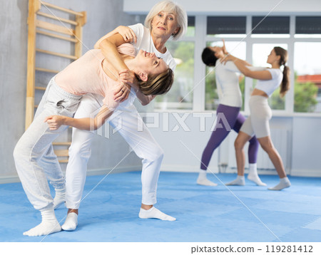 Young and elderly women training self-defense techniques Young and elderly women training self-defense techniques 119281412