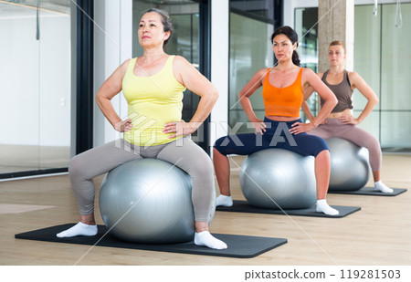 Women in sportswear, pilates training on balls in gym. Fitness workuot in sport gym 119281503