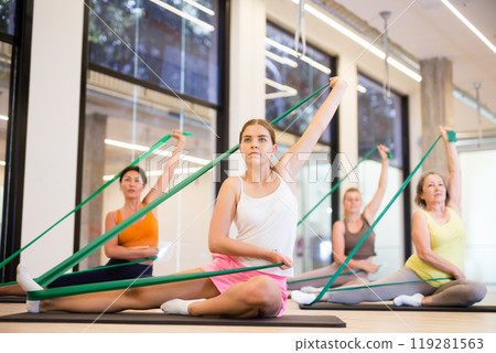 Group of women doing stretch exercises Group of women doing stretch exercises 119281563