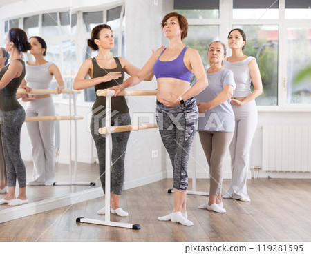 Group of women participating beginner ballet class with instructor Group of women participating beginner ballet class with instructor 119281595