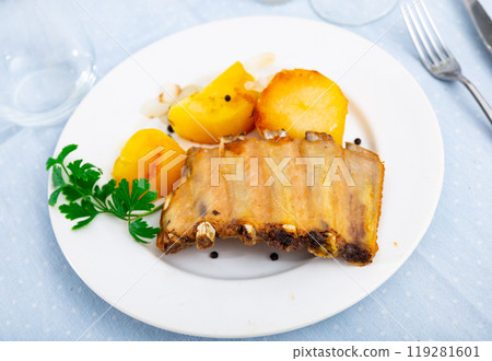 Beautiful serving of grilled pork ribs with baked potatoes Beautiful serving of grilled pork ribs with baked potatoes 119281601