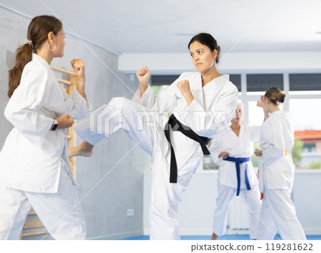 Two women trained to perform basic defensive karate installations and attacking combat techniques 119281622