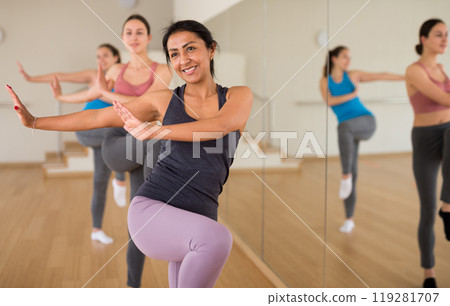Portrait of young smiling hispanic woman dancing 119281707