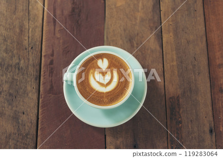 Latte art coffee cup with milk on wooden table. Espresso shot make latte art hot coffee cup. Cappuccino with milk in italian coffee shop cafe. Brown hot caffeine beverage in cafeteria with copy space 119283064