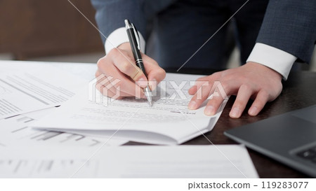 The hands of a businessman checking documents in a hurry The hands of a businessman checking documents in a hurry 119283077