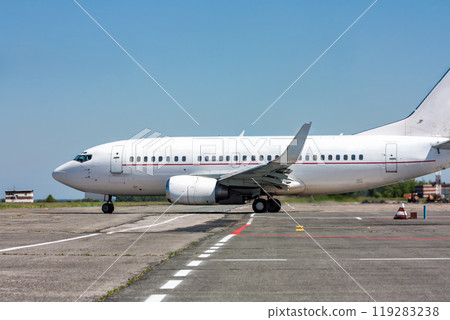Taxiing passenger aircraft on the airport apron Taxiing passenger aircraft on the airport apron 119283238