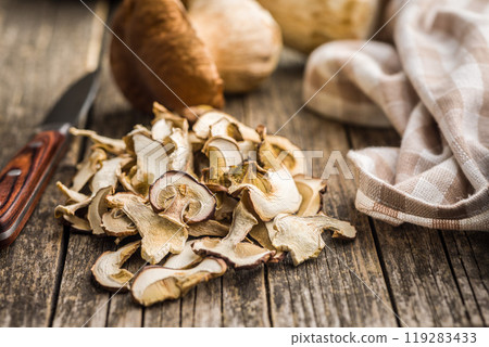 Dried porcini mushrooms. Sliced boletus on wooden table. Dried porcini mushrooms. Sliced boletus on wooden table. 119283433