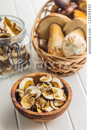 Dried porcini mushrooms. Sliced boletus in bowl on white table. 119283443
