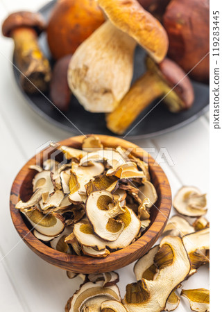 Dried porcini mushrooms. Sliced boletus in bowl on white table. 119283445