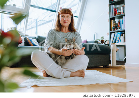 portrait of middle aged woman meditating, yoga at home portrait of middle aged woman meditating, yoga at home 119283975