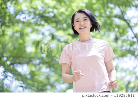 Middle-aged woman enjoying running Middle-aged woman enjoying running 119285611