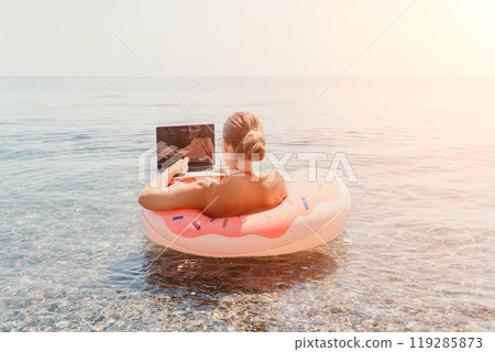 Woman Laptop Beach Working Remotely While Relaxing on Float 119285873