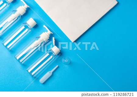 Various clear plastic bottles and containers arranged on a blue background Various clear plastic bottles and containers arranged on a blue background 119286721