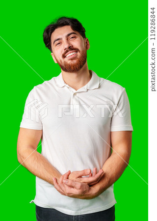 A man with a beard smiles confidently against a bright green background 119286844