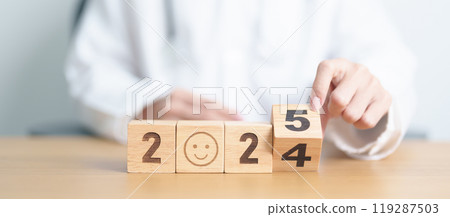 2024 end year to Happy New Year 2025 with Smile block against doctor. Health, Healthcare insurance, medical Satisfaction, feedback, Review, mental health, wellbeing, wellness and good year concept 119287503