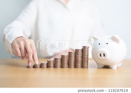 Money Saving for Future Plan, Retirement fund, Pension, Investment, Wealth, Salary and Financial concepts. hand step up coin with piggy bank on table, Money Counting and stack arrangement for Growth 119287619